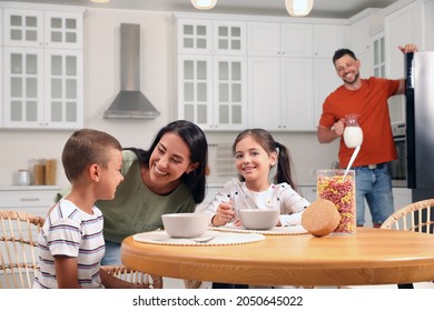 Happy family with children having fun during breakfast at home - Powered by Shutterstock