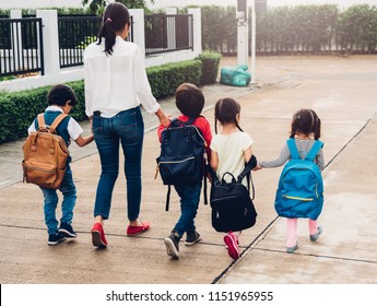 Happy Family Children Kid Boy Son And Daughter Girl Kindergarten Walking Going To Nursery School Holding Hand With Mother Or Mom, Back To School Concept