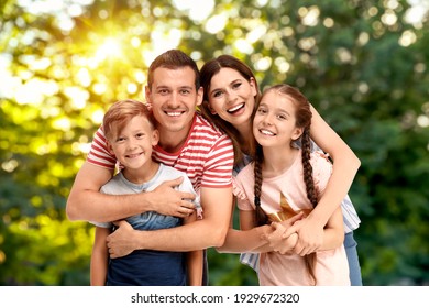 Happy Family With Children Outdoors On Sunny Day