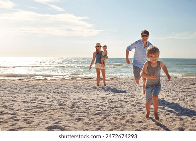 Happy, family and children playing on the beach on holiday, travel or adventure in summer. Boy, father and kids with parents and outdoor ocean for fun energy and happiness with a game while running - Powered by Shutterstock