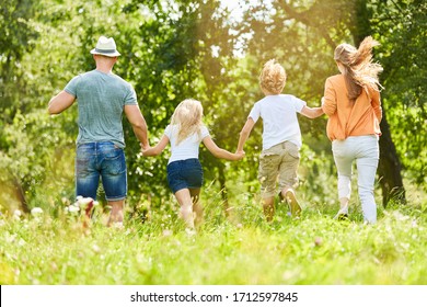 Happy Family And Children In The Summer In Nature