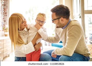 Happy Family Choosing Glasses In Optics Store. 