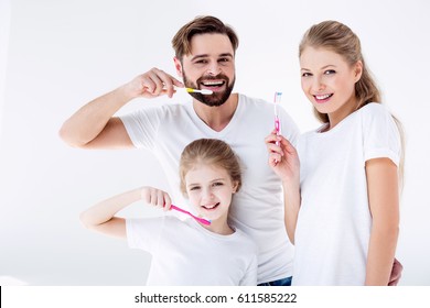 Happy Family Cleaning Teeth With Toothbrushes Together Isolated  On White