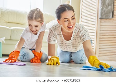 Happy Family Cleans The Room. Mother And Daughter Do The Cleaning In The House. A Young Woman And Child Girl Are Dusting. Cute Little Helper.