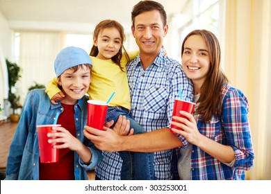 Happy Family With Coke Looking At Camera