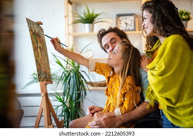 Happy Family Concept. Young Parents With Children Painting Together At Home. People Fun Happyiness.