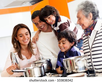 Happy Family Cooking Together At Home And Smiling