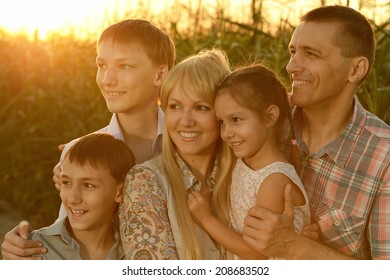 Happy Family In Corn Field In Evening