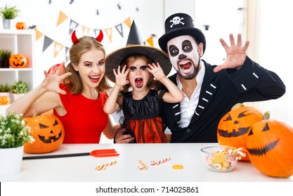 A Happy Family In Costumes Getting Ready For Halloween At Home