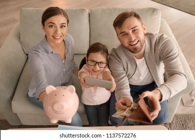 Happy Family Counting Money Indoors. Money Savings Concept