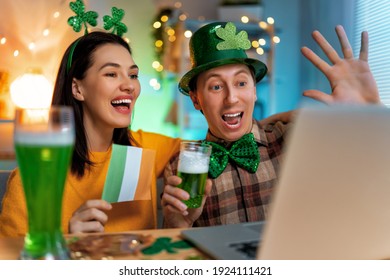 Happy family couple celebrating St. Patrick's Day with their friends by online at home. - Powered by Shutterstock