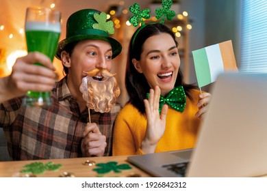 Happy family couple celebrating St. Patrick's Day with their friends by online at home. - Powered by Shutterstock