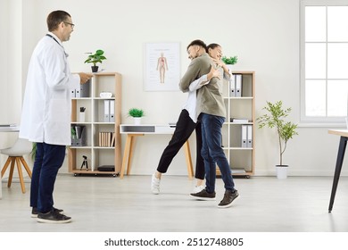 Happy family couple embraces during a consultation with a gynecologist at the hospital, focusing on pregnancy planning or IVF. The doctor provides care and guidance for journey to parenthood. - Powered by Shutterstock