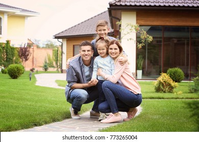 Happy family in courtyard near their house