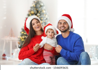 Happy Family With Cute Baby At Home. Christmas Celebration