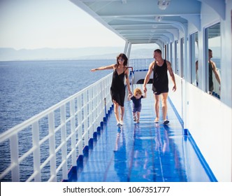 Happy family with cute son on summer vacation. Family travelling on cruise ship on sunny day. Family rest concept. Father, mother and child walk on deck of cruise liner with sea on background. - Powered by Shutterstock