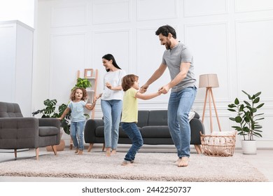 Happy family dancing and having fun in living room