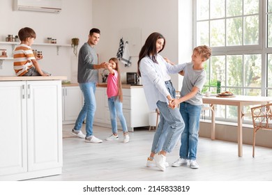 Happy  Family Dancing In Kitchen