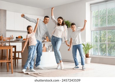 Happy family dancing in kitchen - Powered by Shutterstock