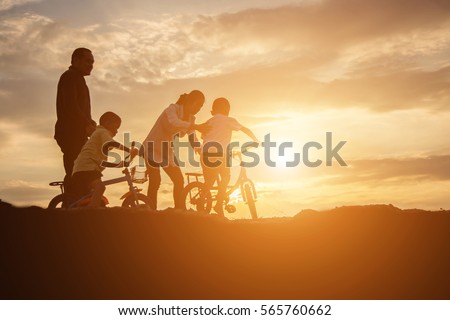 Happy family dancing on the road in the sunset time. Evening party on the nature