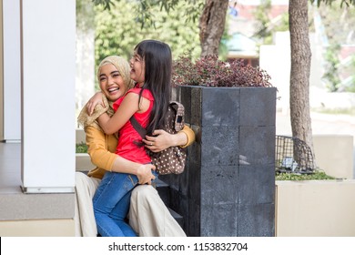 Happy Family Daughter Running And Hugging Mum After Going Back From School