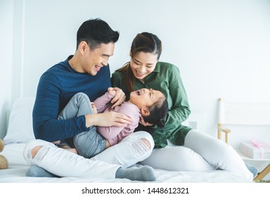 Happy Family With Daughters Playing At Home And Weekend For Family