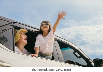 Happy family day. Asian mother father and children smiling sitting in compact white car looking out windows, Summer at the beach, Car insurance, Family holiday vacation travel, road trip concept - Powered by Shutterstock