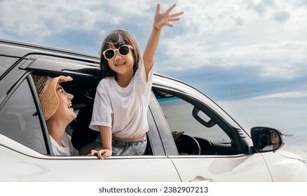 Happy family day. Asian mother father and children smiling sitting in compact white car looking out windows, Summer at the beach, Car insurance, Family holiday vacation travel, road trip concept - Powered by Shutterstock