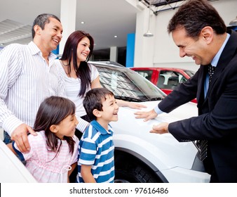 Happy Family With The Dealer Buying A New Car