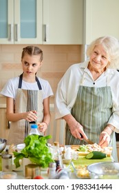 Happy Family Different Generations Cooking Together, Chopping Food For Lunch, Preparing Delicious Tasty Meal For Family, Having Talk, Teach And Learn Cooking, Grandparents And Grandchildren