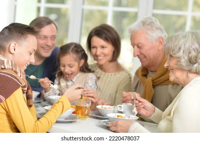 Happy Family Of Different Generations Eating Together In The Kitchen