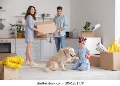 Happy Family With Dog And Boxes In Kitchen On Moving Day