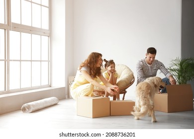 Happy Family With Dog And Moving Boxes In Their New House