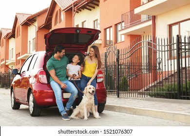 Happy Family With Dog Near Car On Street