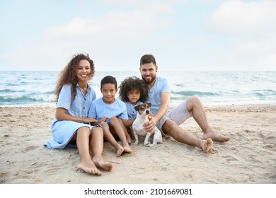 Happy Family With Dog On Sea Beach