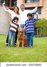 Happy Family With A Dog Outside Theit House