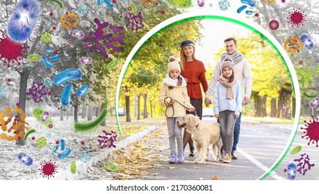 Happy Family With Dog Walking In Autumn Park. Concept Of Strong Immunity