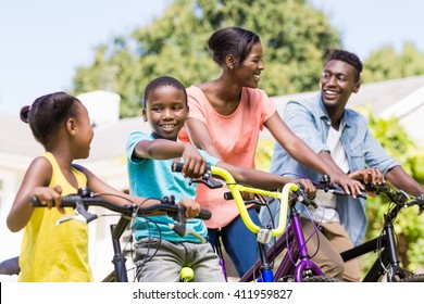 Happy Family Doing Bicycle At Park