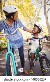 Happy family doing bicycle at park - Shutterstock ID 448336267