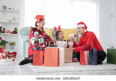 Happy Family Doing Online Shopping And Buying Presents In Christmas Day