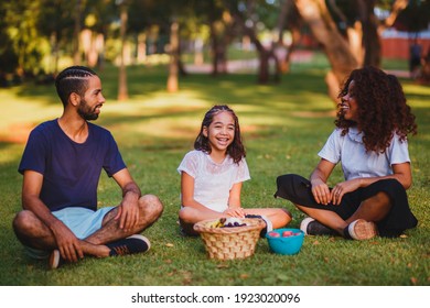 Happy Family Doing Picnic In The Park