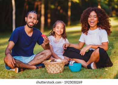 Happy Family Doing Picnic In The Park