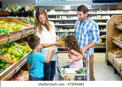 Happy Family Doing Shopping In Grocery Store