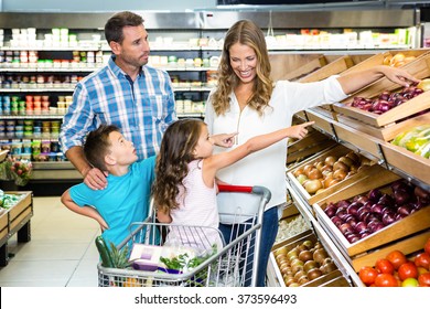 Happy Family Doing Shopping In Grocery Store