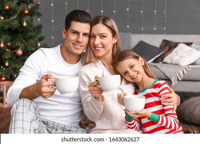 Happy Family Drinking Hot Chocolate On Christmas Eve At Home