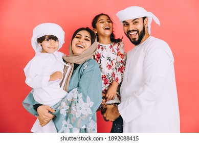 Happy family in Dubai. parents and children with traditional emirati clothes taking portraits
