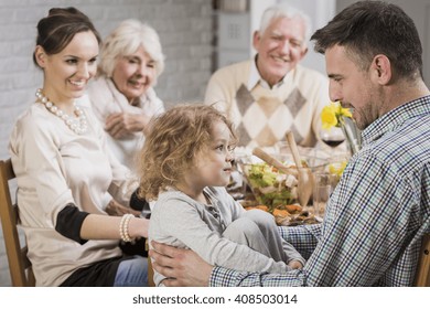 Happy Family During Dinner Celebrating Father's Day, Smiling