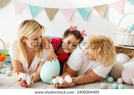 happy family with easter eggs. Happy llittle girl and grandmother with Easter eggs