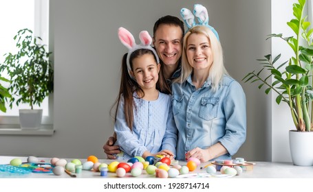 Happy Family With Easter Eggs. Happy Family Preparing For Easter