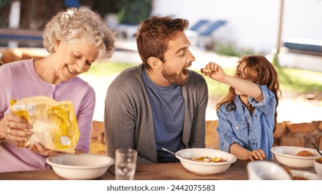 Happy family, eating and breakfast in garden of home for nutrition, bonding and relax together with porridge. Father, grandma and child with healthy diet, meal and feed at dining table in the morning - Powered by Shutterstock